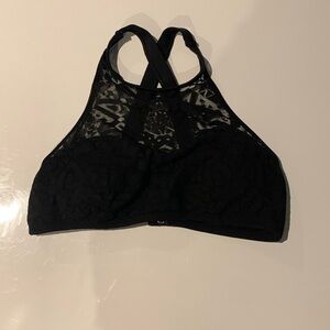 This is a black sporty looking swimsuit top.